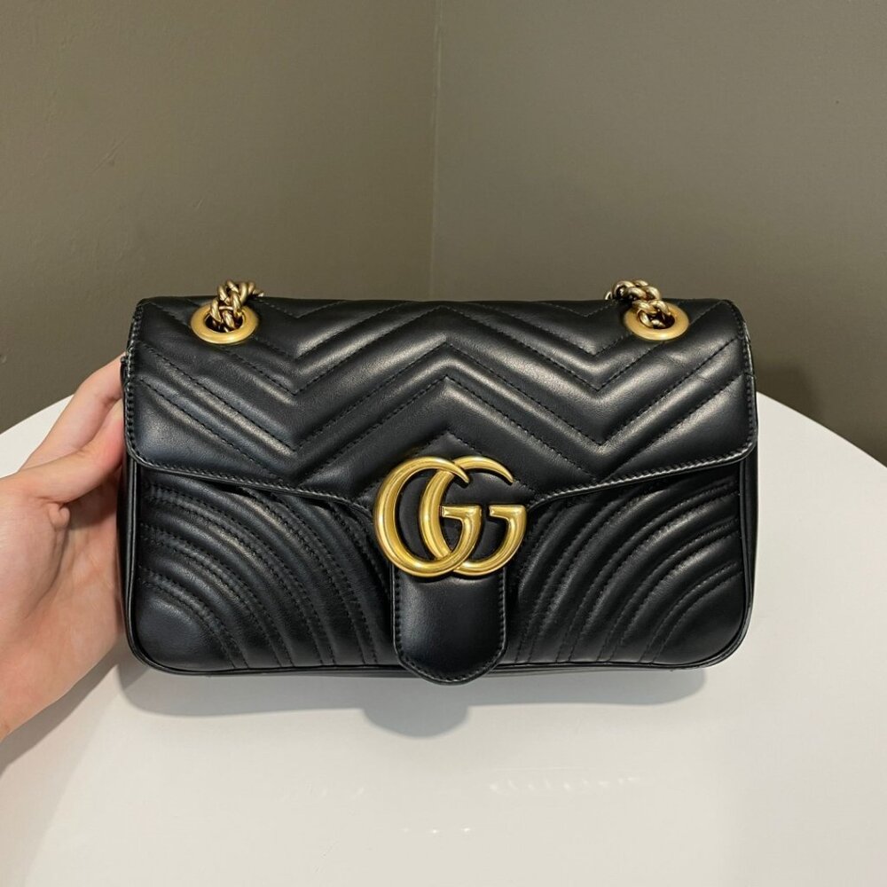 Gucci GG Marmont quilted leather black shoulder bag with gold chain.
